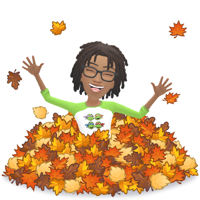 Ree laughing in a pile of colourful autumn leaves
