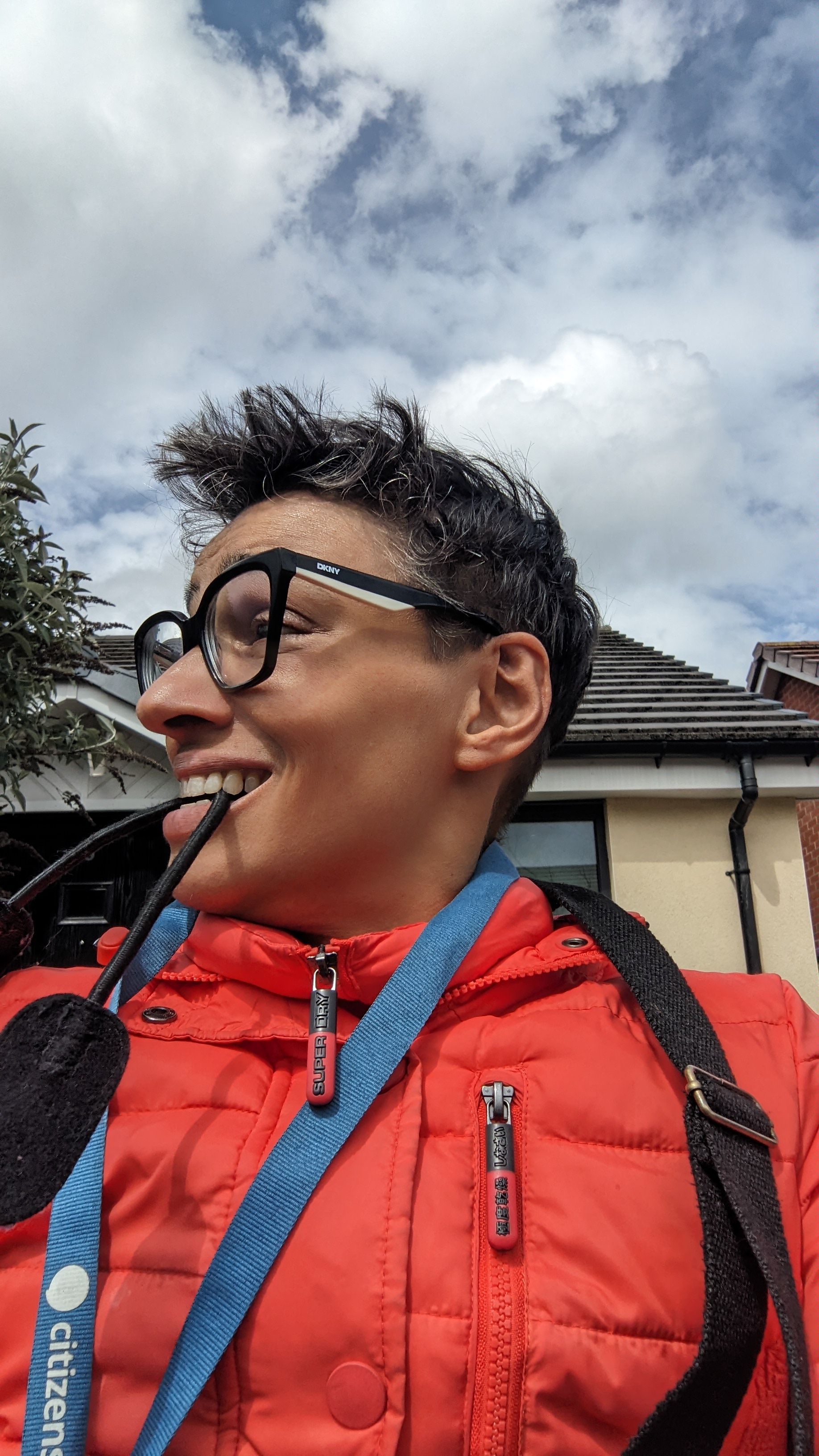 Marie Meronym outdoors, smiling in a bright red jacket